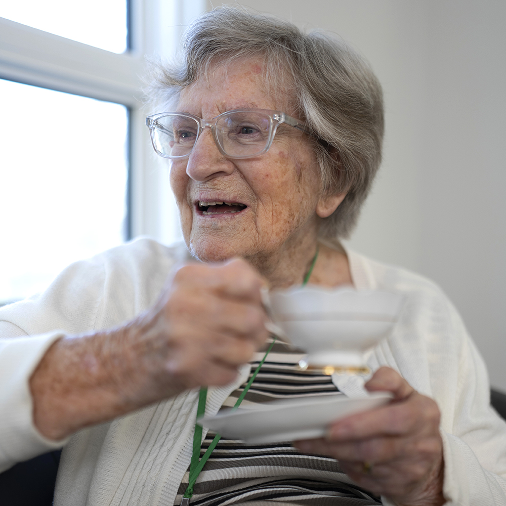 Resident enjoying a relaxing cup of tea during a short stay at Atrium Retirement Residence in Orillia